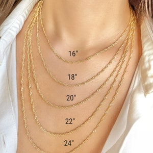 Five gold chain necklaces of different lengths, 16 inches, 18 inches, 20 inches, 22 inches, and 24 inches, are shown on a model's neck. The chains are all 2.5mm thick.