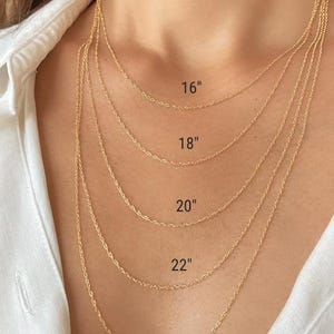 Five real 14k solid gold twisted rope chains of different lengths, 16 inches, 18 inches, 20 inches, 22 inches, and 24 inches, are layered on a model's neck. The chains are all the same width, 1.2mm.
