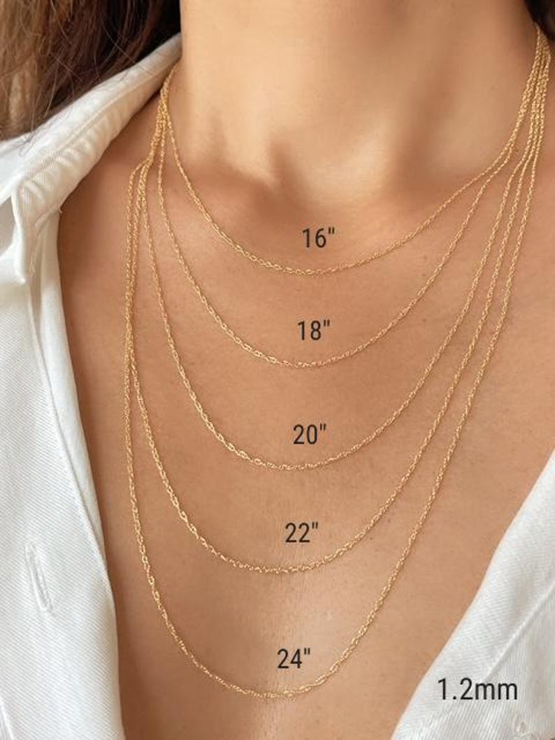 Five real 14k solid gold twisted rope chains of different lengths, 16 inches, 18 inches, 20 inches, 22 inches, and 24 inches, are layered on a model's neck. The chains are all the same width, 1.2mm.