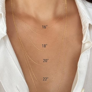 Five 14k solid gold twisted rope chains of different lengths, 16 inches, 18 inches, 20 inches, 22 inches, and 24 inches, are layered on a model's neck. The chains are all the same width, 0.7mm.