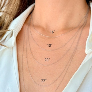 Five 14k white solid gold twisted rope chains of different lengths, 16 inches, 18 inches, 20 inches, 22 inches, and 24 inches, are layered on a model's neck. The chains are all the same width, 0.7mm.