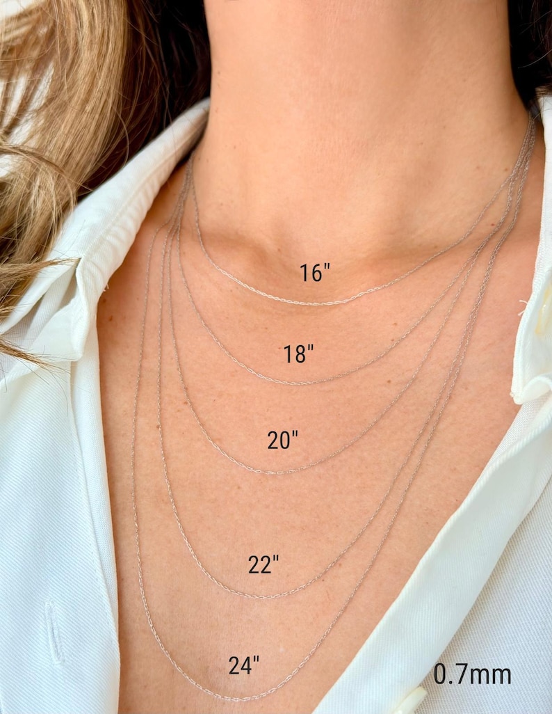 Five 14k white solid gold twisted rope chains of different lengths, 16 inches, 18 inches, 20 inches, 22 inches, and 24 inches, are layered on a model's neck. The chains are all the same width, 0.7mm.