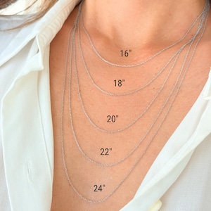 Five 14k solid white gold twisted rope chains of different lengths, 16 inches, 18 inches, 20 inches, 22 inches, and 24 inches, are layered on a model's neck. The chains are all the same width, 1mm.