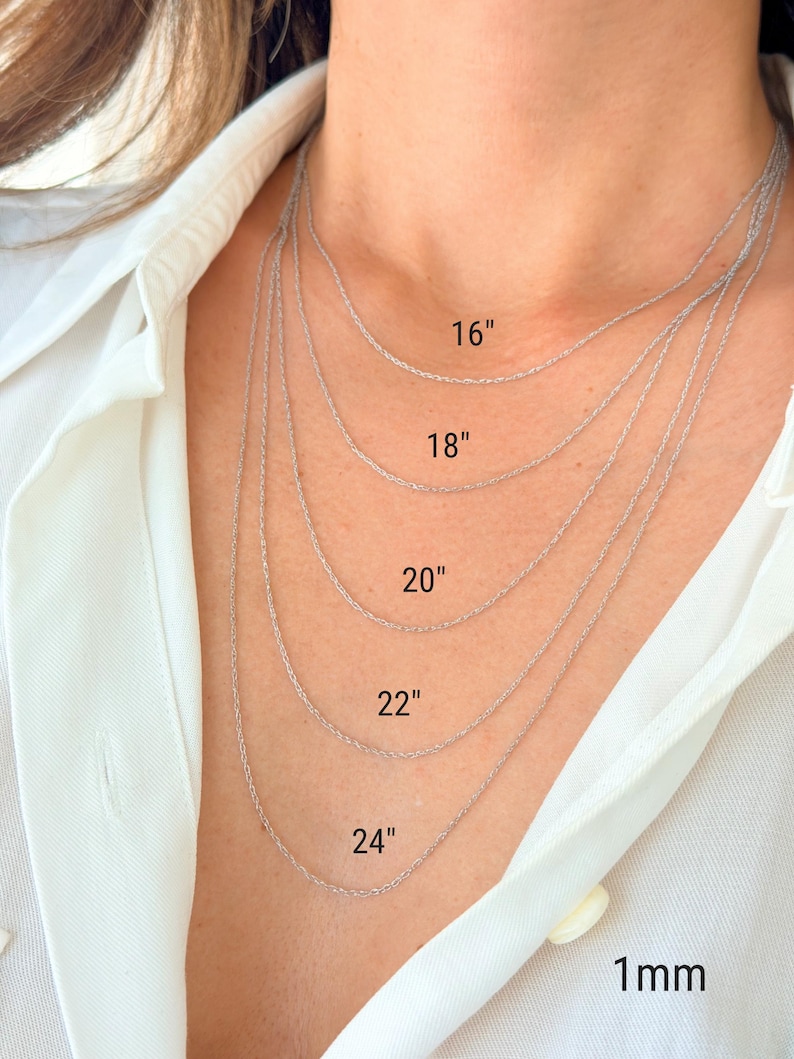 Five 14k solid white gold twisted rope chains of different lengths, 16 inches, 18 inches, 20 inches, 22 inches, and 24 inches, are layered on a model's neck. The chains are all the same width, 1mm.