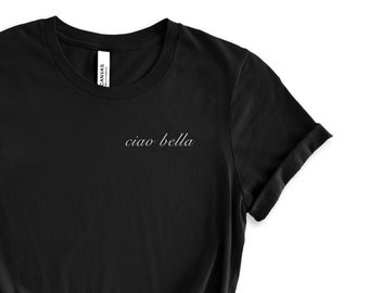 May include: Black t-shirt with the text "ciao bella" in white lettering.