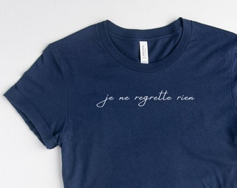 May include: A navy blue t-shirt with the text "je ne regrette rien" in white script.