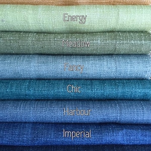 May include: A stack of eight fabric swatches in various shades of blue, green, and brown. The swatches are labeled with the names "Bangle", "Energy", "Meadow", "Fancy", "Chic", "Harbour", "Imperial", and "Thrill".