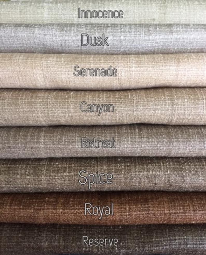 May include: Close-up of eight fabric swatches in various shades of brown and beige. The swatches are labeled with the names "Innocence", "Dusk", "Serenade", "Canyon", "Retreat", "Spice", "Royal", and "Reserve".