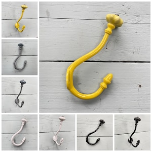 May include: Set of ten decorative hooks in various colours, including yellow, grey, pink, and black. Each hook features a unique ceramic knob at the top.