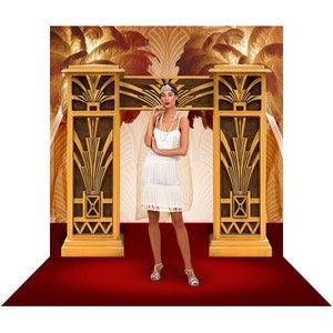 May include: A woman in a white flapper dress stands in front of a gold art deco backdrop. The backdrop features two tall, ornate pillars with geometric designs. The woman is wearing a headband and a pearl necklace.