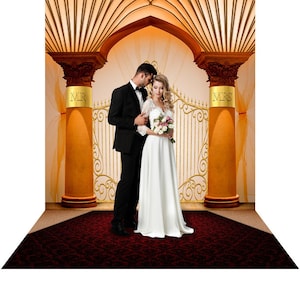 May include: A wedding backdrop featuring a golden gate with ornate details, two pillars with the words "MR" and "MRS" on them, and a couple standing in front of the gate. The couple is dressed in formal attire, and the woman is holding a bouquet of flowers.