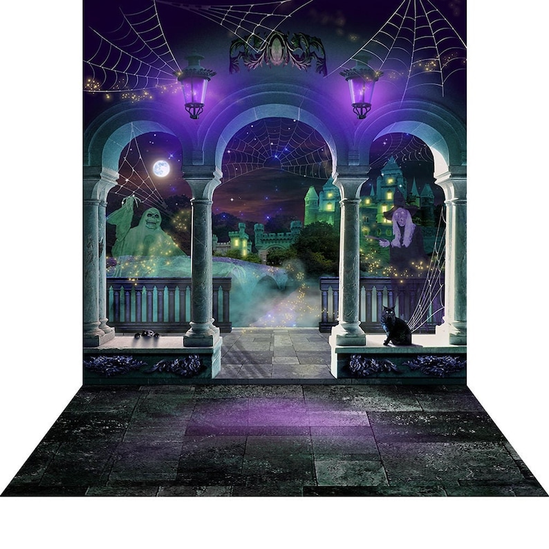 A Halloween photo backdrop with a stone balcony, arches, a glowing green castle, a ghost, a witch figure, a black cat, and spiderwebs against a purple night sky.