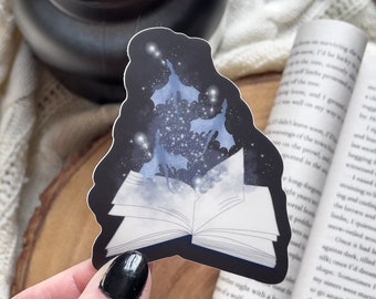May include: A sticker of an open book with blue butterflies flying out of it against a dark blue starry background.