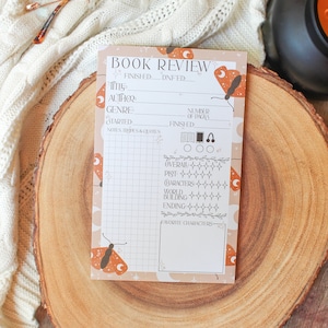 May include: A printable book review tracker with a whimsical design featuring butterflies and moons. The tracker includes sections for title, author, genre, number of pages, overall rating, plot, characters, world building, ending, and favorite characters.