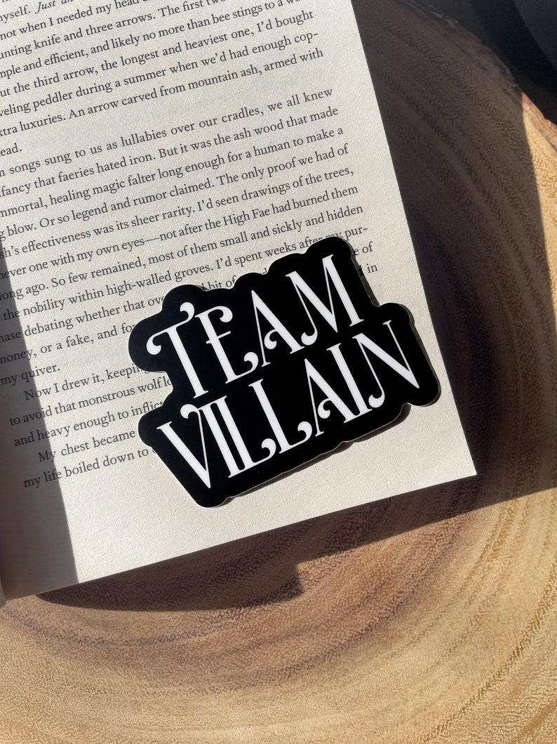 May include: Black and white sticker with the text "TEAM VILLAIN" in bold white letters on a black background.