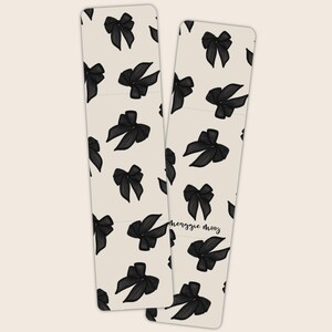 May include: Two bookmark designs with black bows on a white background. The text "Meaggie Mooz" is on the right bookmark.