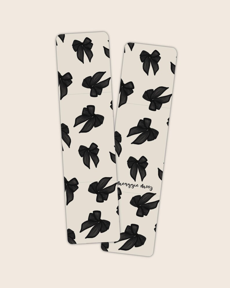 May include: Two bookmark designs with black bows on a white background. The text "Meaggie Mooz" is on the right bookmark.