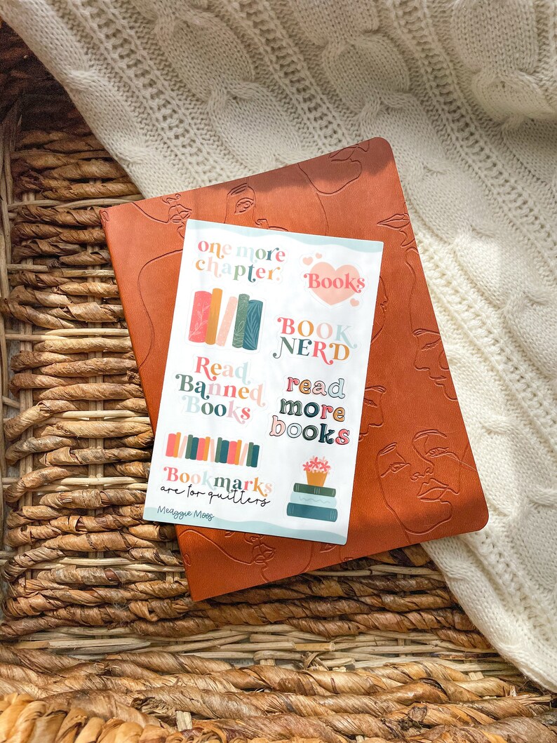 May include: A set of colorful book-themed stickers with text that reads "one more chapter", "Books", "Book Nerd", "Read Banned Books", "read more books", and "Bookmarks are for quitters Meaggie Moos".