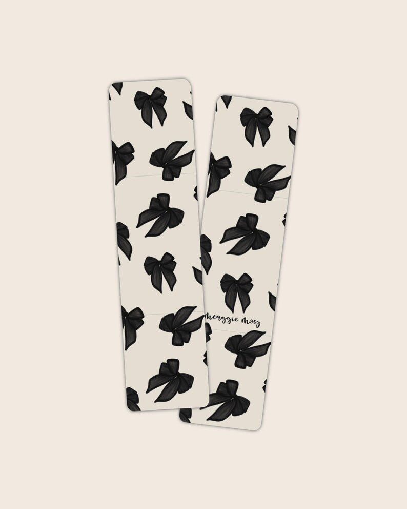 May include: Two black and white bookmark designs with a repeating pattern of black bows. The text "heggie mooy" is written on the bottom right bookmark.