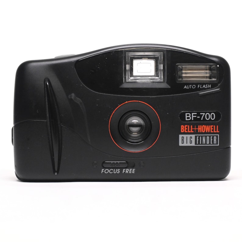 Pode incluir: Uma c&acirc;mera preta Bell+Howell BF-700 Big Finder com uma lente de foco livre e um flash autom&aacute;tico.