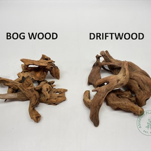 May include: Two types of wood for aquariums: bog wood and driftwood. The bog wood is a light brown color and has a more natural, branch-like shape. The driftwood is a darker brown color and has a more gnarled, twisted shape.