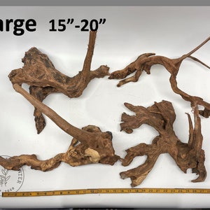 May include: A large piece of driftwood for aquariums, measuring 15 to 20 inches in length. The driftwood is brown and has a natural, weathered look.