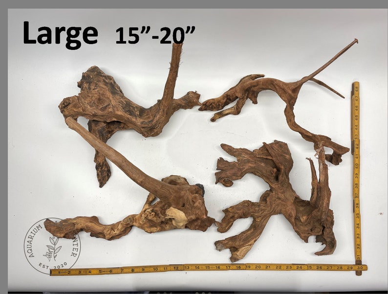 May include: A large piece of driftwood for aquariums, measuring 15 to 20 inches in length. The driftwood is brown and has a natural, weathered look.