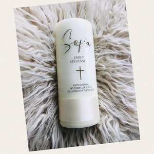 May include: White baptism candle with gold lettering. The candle reads "Sofia", "Emily Stevens", a cross, "Baptised on 18th February 2024", and "St. Anthony's Church".