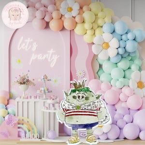 May include: A green troll character with a crown and a red and white striped shirt stands in front of a pink and white balloon arch. The balloons are arranged in a flower shape. The text "Let's Party" is on the pink wall behind the troll.