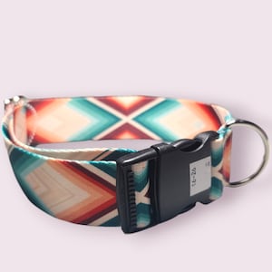 May include: A colorful dog collar with a geometric pattern in shades of teal, orange, and red. The collar has a black buckle with the size "16-26" printed on it.