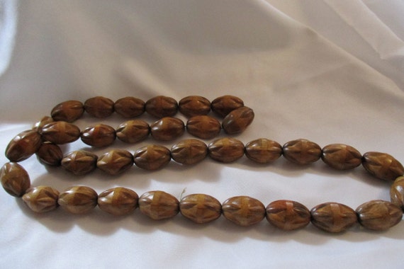 Varied Shades of Brown Carved Kukui Nut Necklace - image 1