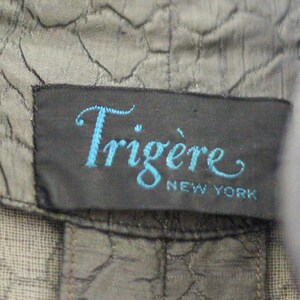 May include: A black label with the text "Trigere New York" in blue cursive lettering.