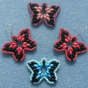 May include: Three pairs of beaded earrings in the shape of butterflies. The earrings are made with black, red, pink, and blue beads.