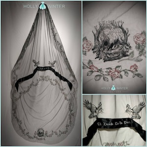 May include: Black tulle wedding veil with embroidered details. The veil features a skull, birds, roses, and the text "Til Death Do Us Part".