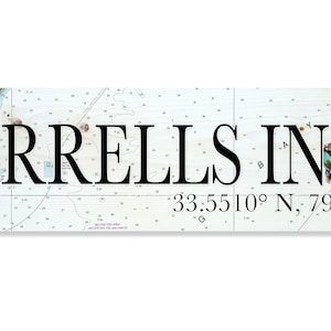 May include: A nautical-themed wooden sign with the text "Murrells Inlet" and the coordinates "33.5510° N, 79.0414° W". A blue crab is depicted on the right side of the sign.
