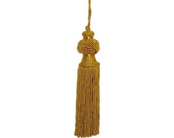May include: A gold tassel with a knotted top and a long fringe. The tassel is made of a soft, silky material and has a delicate, elegant look.
