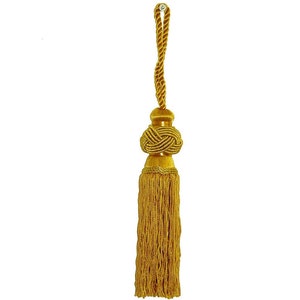 May include: A gold tassel with a knotted top and a long fringe. The tassel is attached to a gold cord.