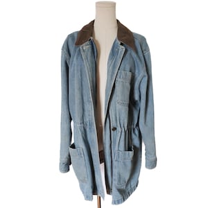 May include: Light blue denim jacket with a brown corduroy collar. The jacket has two front pockets, a drawstring waist, and a button closure. The jacket is displayed on a mannequin.