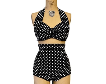 May include: Black and white polka dot swimsuit with a halter top and high-waisted bottoms.