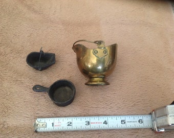 Brass and cast iron coal buckets and pot