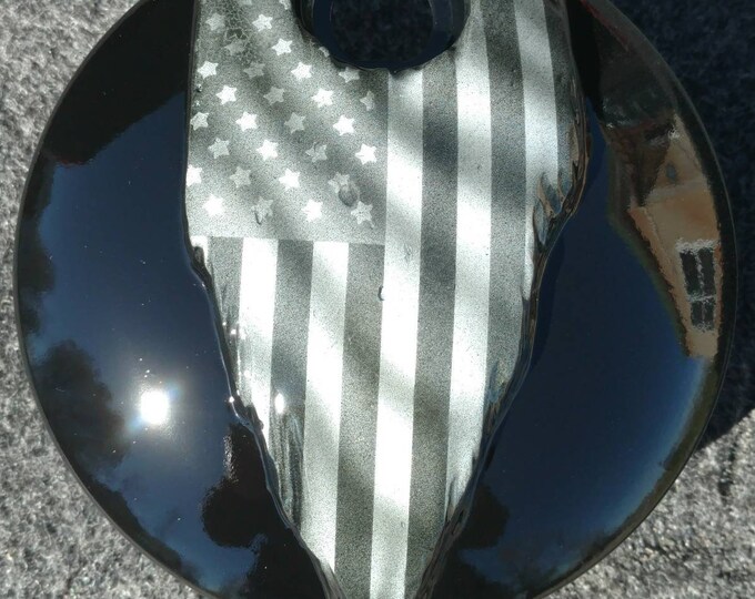 Tattered American flag on a Harley Davidson touring fuel door