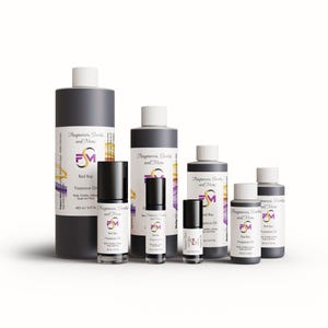 May include: A collection of fragrance oil bottles and roll-ons in various sizes. The bottles are dark gray with white caps and labels. The labels feature the text "Bad Boy" and the brand logo. The products are for body candles, lotions, soaps, and more.