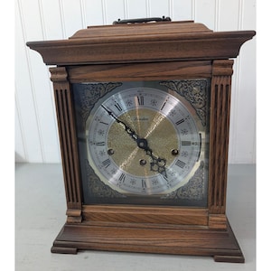 May include: A white ceramic mug with a black handle and the text "But First, Coffee" in a handwritten style. The mug is on a white surface. The mug is 4 inches tall.