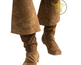 May include: A pair of brown suede knee-high boots with a fold-over cuff. The boots have a pointed toe and a low heel.