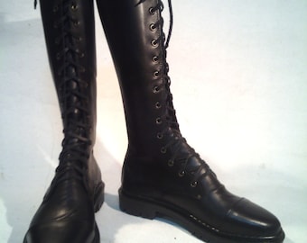 May include: A pair of black leather knee-high boots with lace-up fronts. The boots have a chunky heel and a rounded toe.
