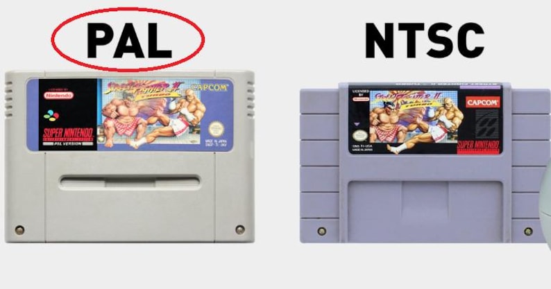 May include: Two Super Nintendo Entertainment System game cartridges for Street Fighter II: The World Warrior. The left cartridge is labeled "PAL Version" and the right cartridge is labeled "Super Nintendo Entertainment System".