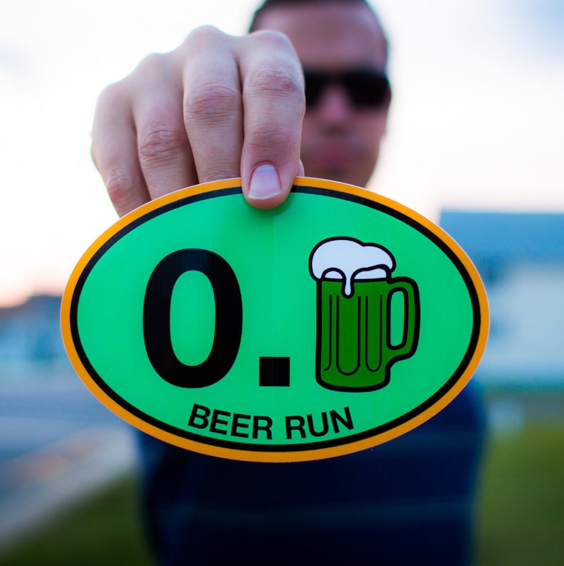 May include: A green and yellow oval sticker with the text "0.1 Beer Run" and a cartoon image of a green beer mug.