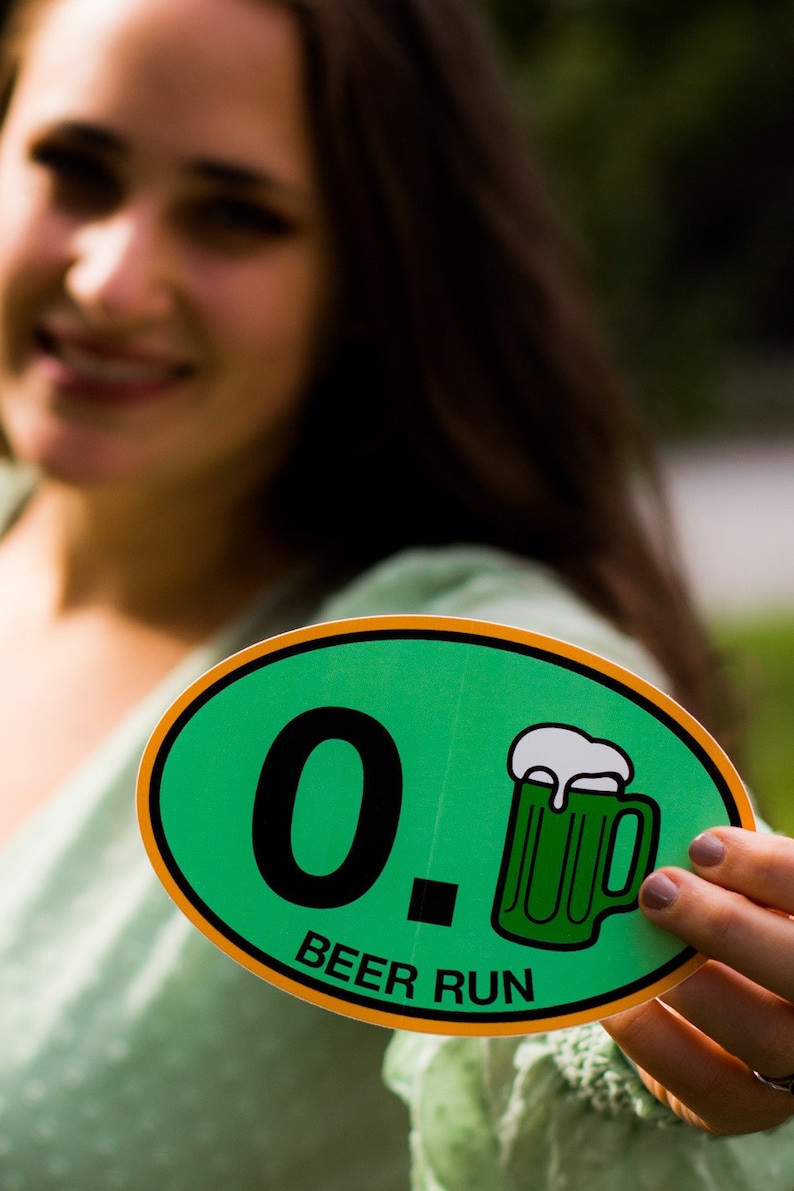 May include: A green and orange oval sticker with the text "0. BEER RUN" and a cartoon image of a green beer mug with white foam.