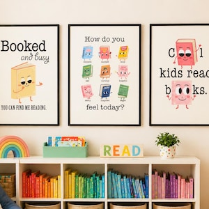 May include: Three framed art prints with book illustrations and text. The prints read "Booked and busy," "How do you feel today?" and "Cool kids read books." A blue beanbag chair, rainbow, and colourful books are also visible.