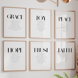 May include: Six framed prints with gold frames, each featuring a different word in bold, "GRACE", "JOY", "PEACE", "HOPE", "TRUST", and "FAITH". Each print includes a Bible verse related to the word.